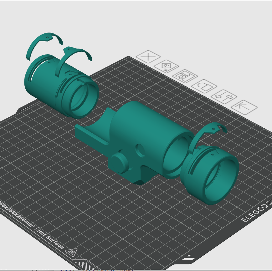 3D model of a teal mechanical object on a grid surface with design tools above.